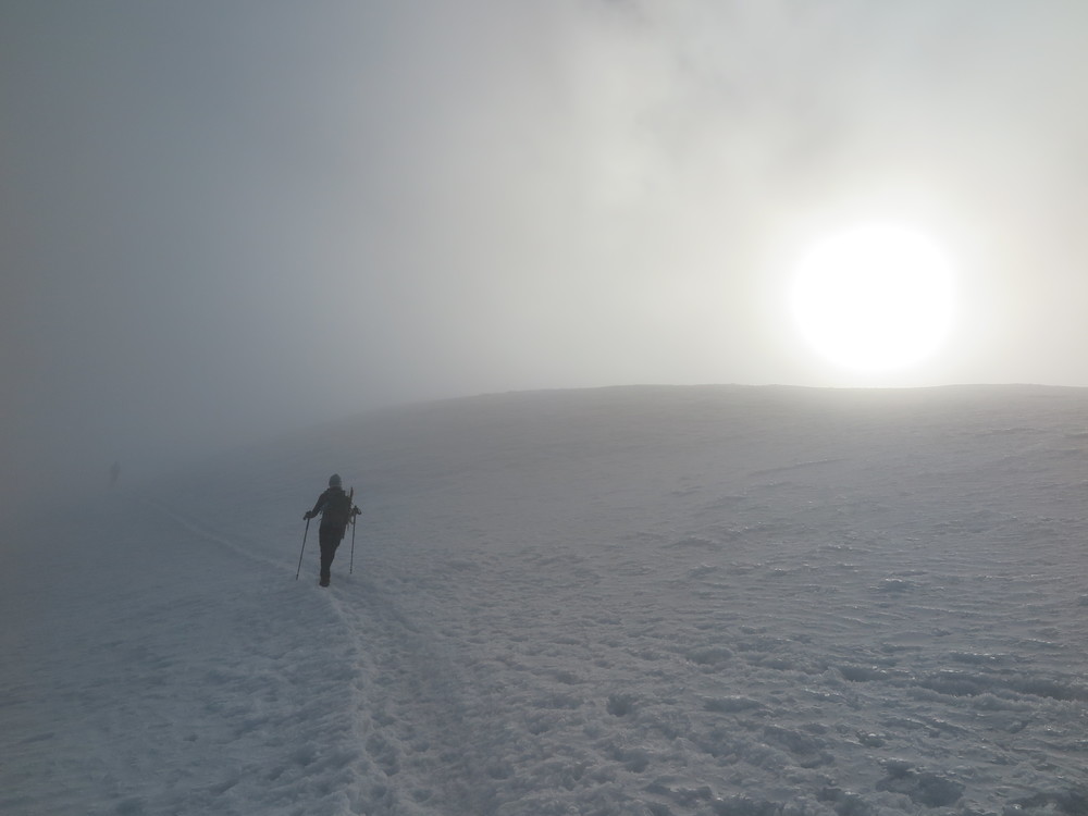Traversing from Piker's Peak to the final summit push in a cloud - with the sun just barely breaking through.
